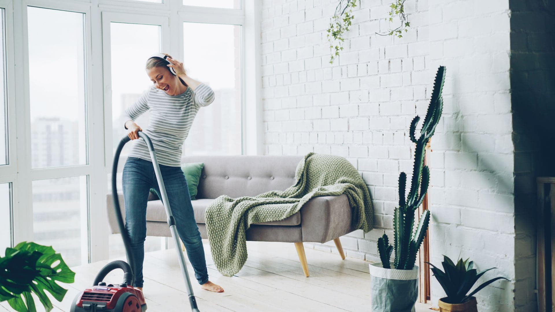 Cleaner vacuuming an apartment living room