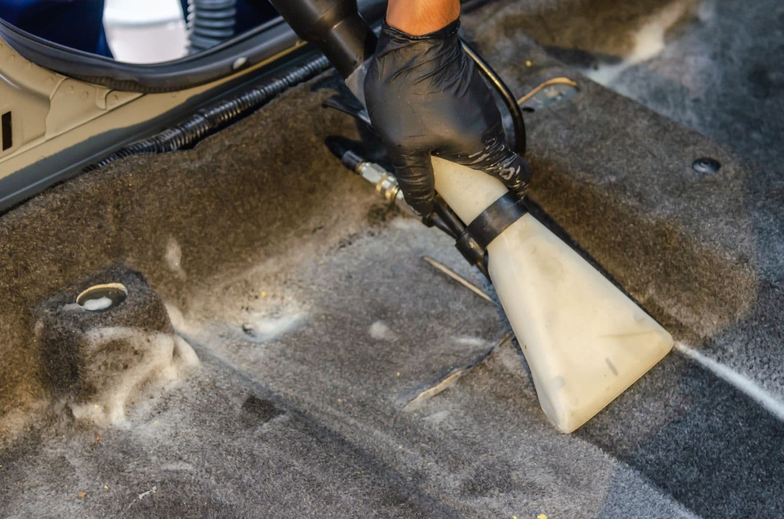 Carpet extraction tool leaving a clean stripe through dirty carpet: before and after in one shot