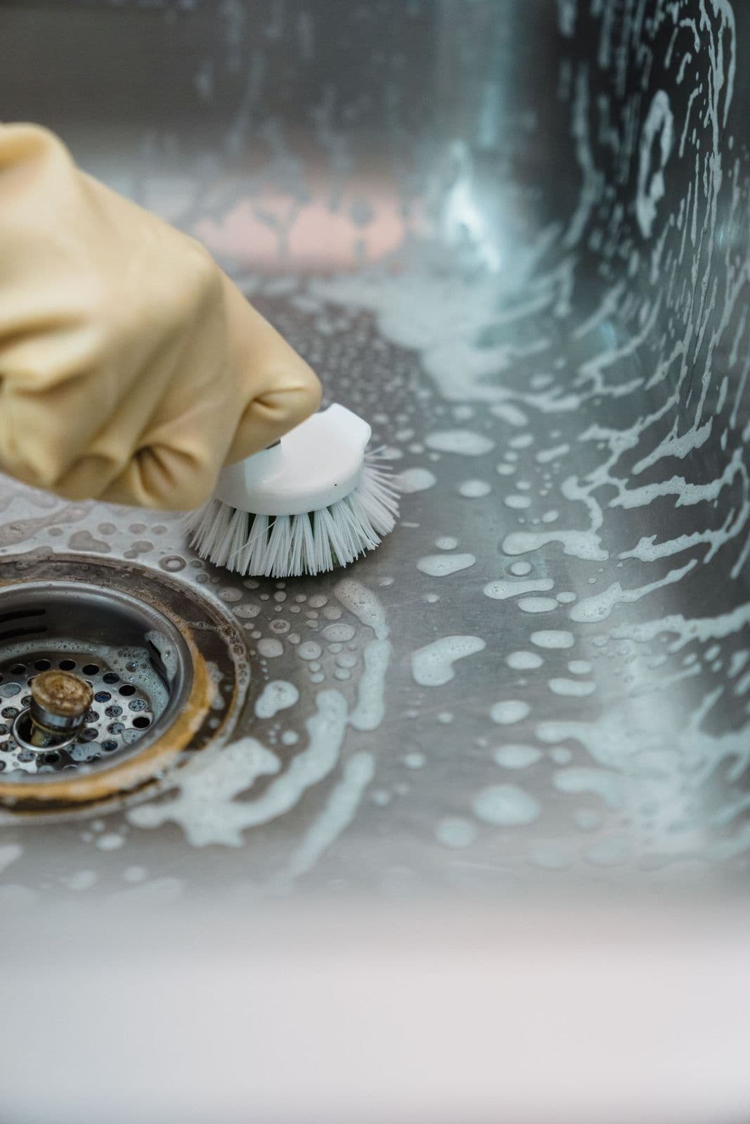 Sink being scrubbed with a brush and foam
